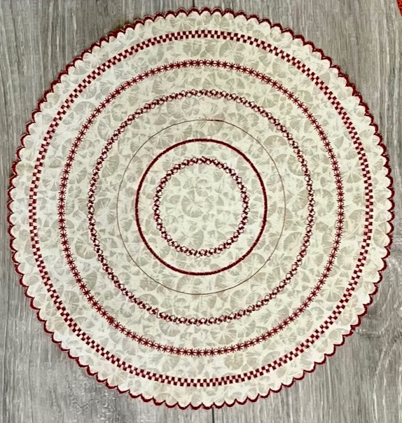 Circle embroidered with Circular embroidery attachment #83 & red decorative thread, lamp mat