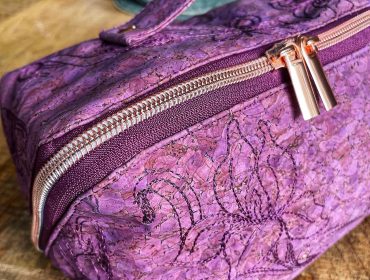 closeup of machine embroidery on cork fabric zip bag