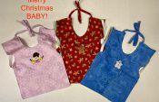 Picture of three full body baby bibs in a horizontal row with small Christmas embroideries on the front